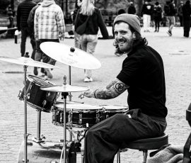 A smile from one of the Central Park drummers as he jams a Latin beat.